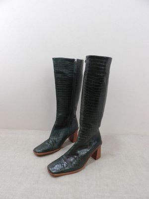 pair of black leather cowboy boots with alligator skin and wooden heel