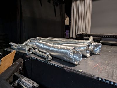 a bunch of metal pipes on a table in a room