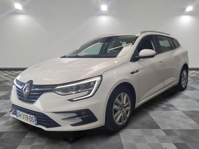 a white car is parked in a room with a checkered floor