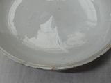 a white bowl sitting on a table with a white table cloth