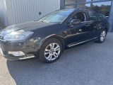 a picture of a black car parked in front of a building