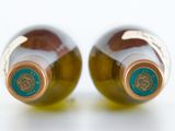 two bottles of wine sitting next to each other on a table