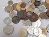 a pile of coins sitting on a white table