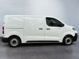 the white van is parked in a room with a gray floor