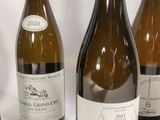 several bottles of wine are lined up on a white surface