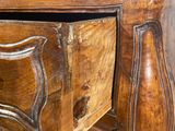 a wooden dresser with a drawer on top of it