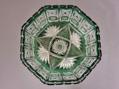 a green glass bowl with a star design on it