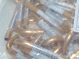 a lot of gold colored scissors in a plastic bag
