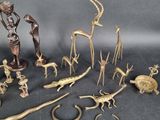 a lot of bronze figurines that are on a table