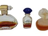a bottle of perfume next to a bottle of perfume on a white background