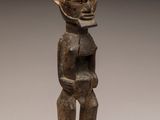 a wooden statue of a man with a helmet on his head