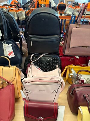 a lot of purses on the table in the store