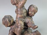 statue of a boy and a girl on a sled with a dog