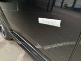 a sticker on the door of a car that is parked in a garage