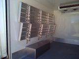 a room with a bunch of metal shelves on the wall
