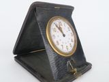 a small clock that is sitting on top of a table