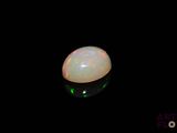 a white oplite in the dark with a green light