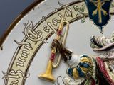 an image of a decorative clock with a man holding a trumpet