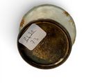 a small cup with a tag on it sitting on a table