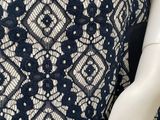 a close up of a mannequin wearing a black and white lace dress