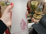 a woman holding a glass vase in her hand