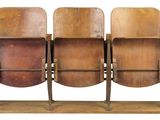 three wooden chairs that are sitting on a wooden stand