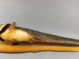 a large horn shaped object on a piece of wood
