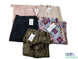 four pairs of pants and a shirt on a white background