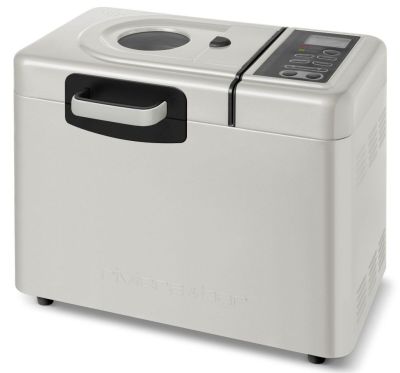 une machine à pain argentée et noire posée sur un plan de travail blanc