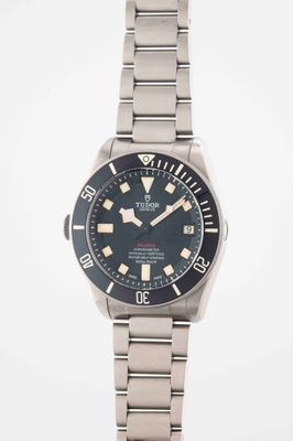 a close up of a watch on a white surface with a white background