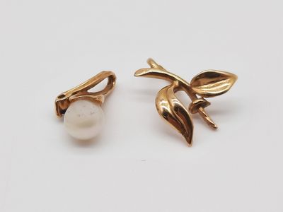 gros plan d'une paire de boucles d'oreilles sur une surface blanche