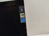 a black laptop with a sticker on it sitting on a table