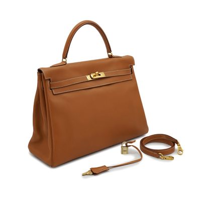 a brown leather handbag with gold hardware and strap
