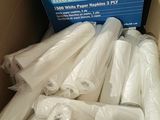many rolls of plastic wrap in a box on the floor