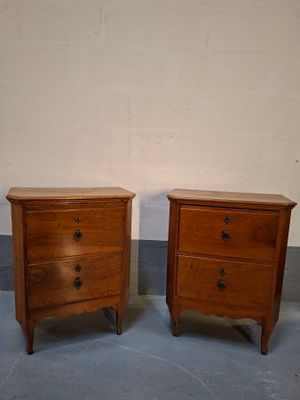 two wooden nightstands sitting side by side on a blue floor