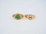a pair of gold rings with emerald stones and pearls