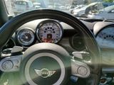a steering wheel and dashboard of a mini cooper