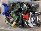 a plastic container filled with assorted video game controllers