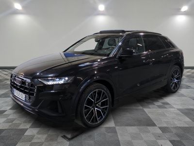 a black audi suv parked on a checkered floor in a garage