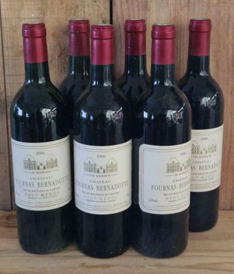 six bottles of red wine are lined up on a wooden shelf