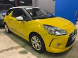 yellow citrole parked in a garage with other cars in the background