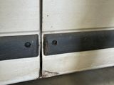a close up of a door handle on a white van
