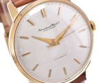 an image of a gold watch with a white dial and brown leather strap