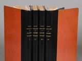 the three books are stacked on top of each other on a gray surface