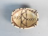 a bowl with a design on it on a table