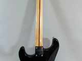 an electric guitar sitting on top of a table next to a wall