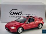 a red toy car that is sitting in front of a box