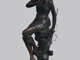 statue d'une femme assise sur un rocher, tenant un fusil