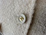 a white button with a gold heart on it