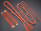 a group of coral beaded necklaces and bracelets